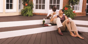 Consider replacing your wood deck with composite material! Here we have a couple enjoying their evening on their new dark-stained composite deck.